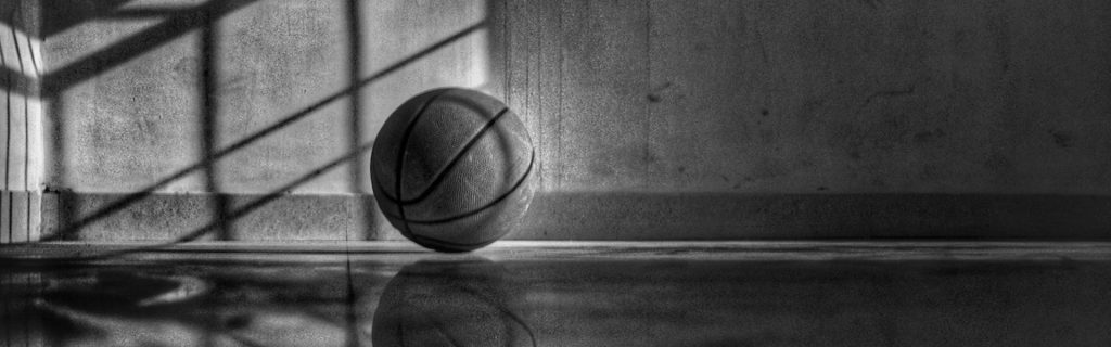 Basketball resting on court grayscale